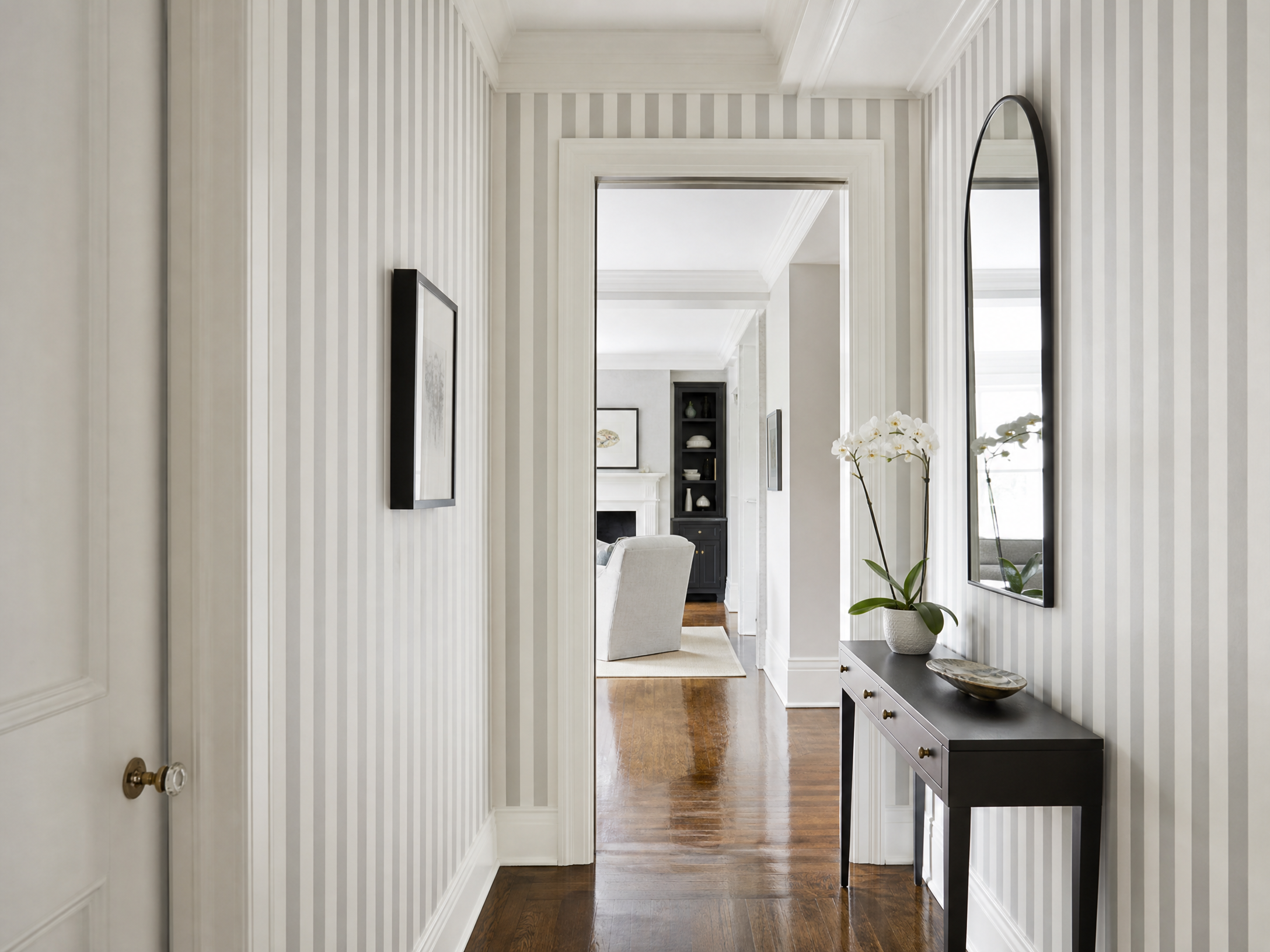 Chic hallway with vertical stripe wallpaper